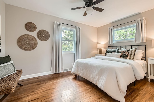 4 Battle Creek Ct, Saint Paul, MN 55119 - bedroom with multiple windows, wood finished floors, and baseboards