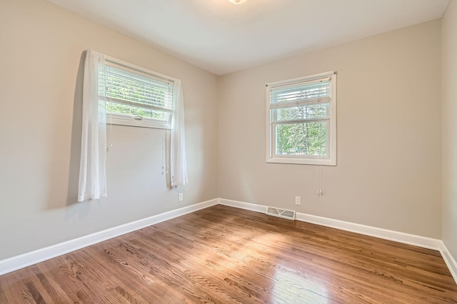 4 Battle Creek Ct, Saint Paul, MN 55119 - spare room with healthy amount of natural light, wood finished floors, and baseboards