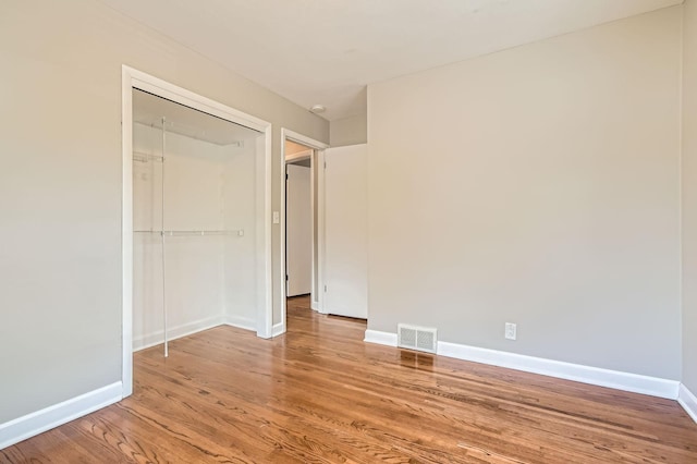 4 Battle Creek Ct, Saint Paul, MN 55119 - unfurnished bedroom featuring light wood finished floors, a closet, and baseboards