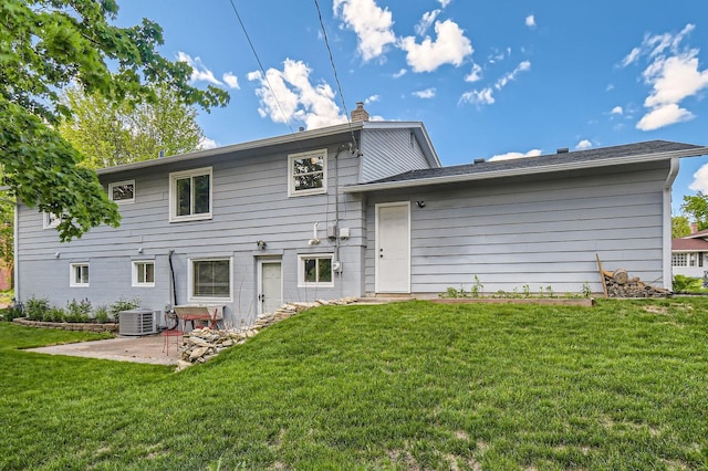 4 Battle Creek Ct, Saint Paul, MN 55119 - back of property featuring a lawn, a patio area, a chimney, and central air condition unit