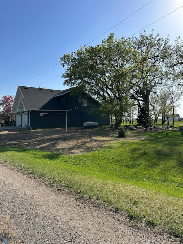 view of home's exterior featuring a garage and driveway