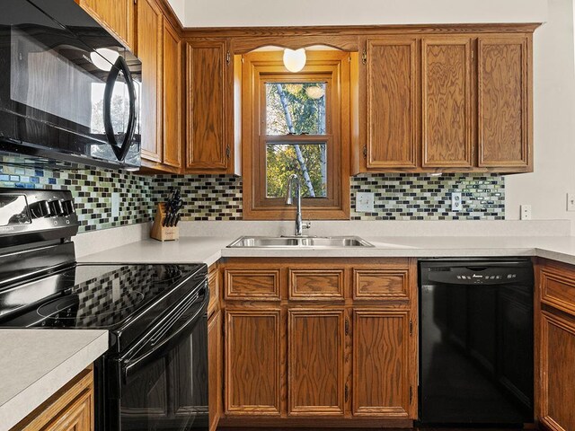 15029 Tyacke Dr, Burnsville, MN 55306 - kitchen with a sink, decorative backsplash, light countertops, and black appliances
