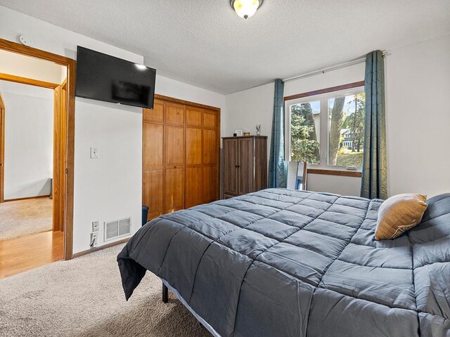 15029 Tyacke Dr, Burnsville, MN 55306 - carpeted bedroom featuring a textured ceiling, a closet, and visible vents