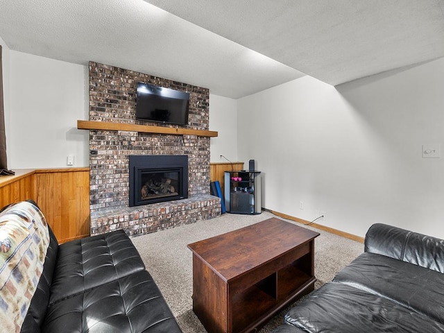 15029 Tyacke Dr, Burnsville, MN 55306 - living room featuring wainscoting, carpet floors, a fireplace, and a textured ceiling