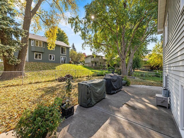 15029 Tyacke Dr, Burnsville, MN 55306 - view of patio / terrace featuring a fenced backyard and a grill