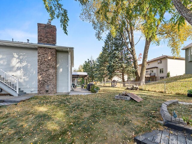 15029 Tyacke Dr, Burnsville, MN 55306 - view of yard with a fenced backyard, stairway, and a patio area