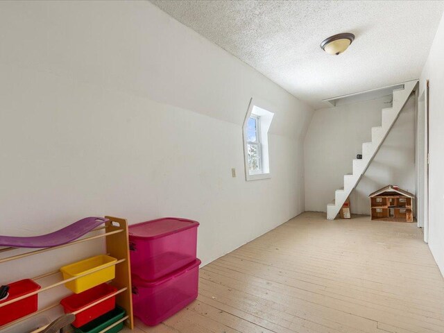 17430 280th St, Sebeka, MN 56477 - bonus room with hardwood / wood-style floors, a textured ceiling, and stairway