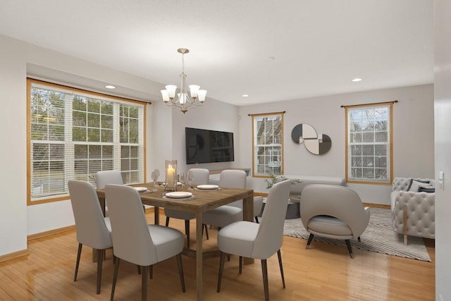 15767 Porchlight Ln, Eden Prairie, MN 55347 - dining space featuring baseboards, light wood-style flooring, recessed lighting, and a notable chandelier