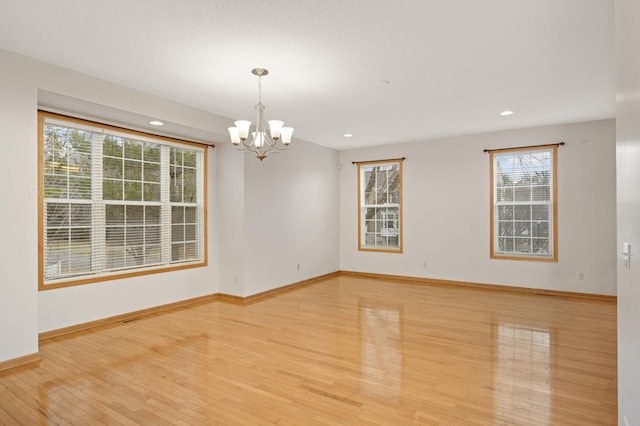 15767 Porchlight Ln, Eden Prairie, MN 55347 - unfurnished room with baseboards, light wood-style floors, recessed lighting, and a chandelier