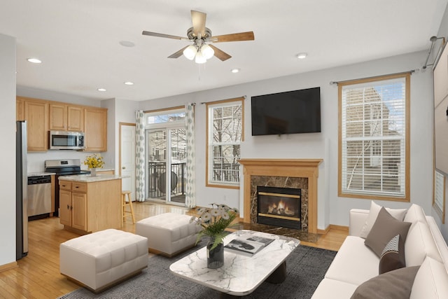 15767 Porchlight Ln, Eden Prairie, MN 55347 - living area with a ceiling fan, a premium fireplace, baseboards, light wood-style floors, and recessed lighting