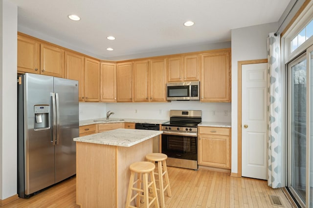 15767 Porchlight Ln, Eden Prairie, MN 55347 - kitchen with a sink, light wood finished floors, stainless steel appliances, light brown cabinets, and visible vents