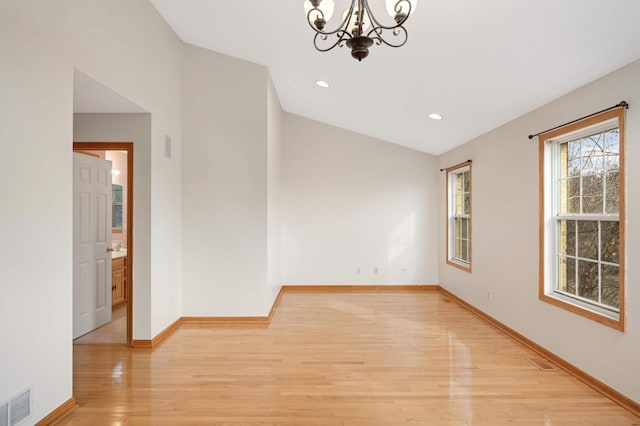 15767 Porchlight Ln, Eden Prairie, MN 55347 - spare room with visible vents, baseboards, a chandelier, and light wood-type flooring