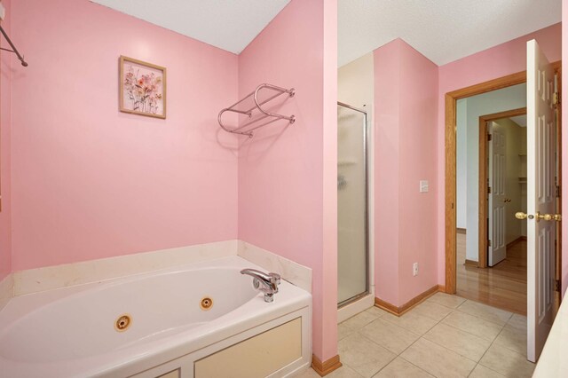 15767 Porchlight Ln, Eden Prairie, MN 55347 - bathroom featuring a tub with jets, tile patterned floors, baseboards, and a shower stall