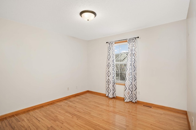 15767 Porchlight Ln, Eden Prairie, MN 55347 - empty room featuring light wood-style flooring, baseboards, and visible vents