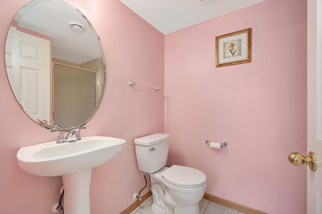 15767 Porchlight Ln, Eden Prairie, MN 55347 - bathroom featuring baseboards, toilet, a stall shower, and tile patterned floors
