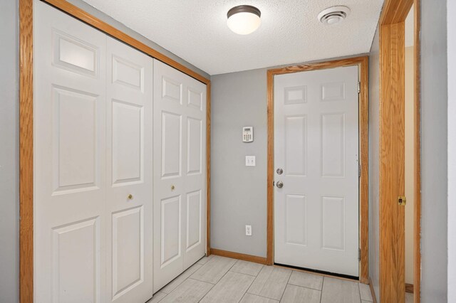 15767 Porchlight Ln, Eden Prairie, MN 55347 - foyer featuring baseboards and a textured ceiling