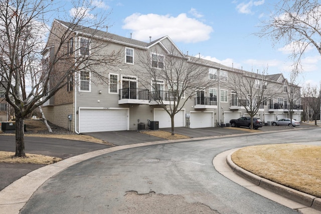 15767 Porchlight Ln, Eden Prairie, MN 55347 - exterior space with driveway, an attached garage, and central air condition unit