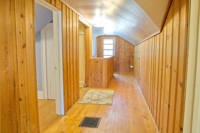 additional living space with vaulted ceiling and wood-type flooring