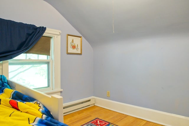 bonus room featuring a baseboard heating unit, vaulted ceiling, wood finished floors, and baseboards