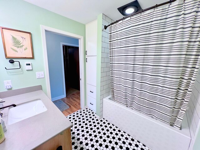 bathroom featuring shower / bath combo and vanity