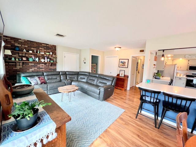 living area featuring visible vents and light wood-type flooring