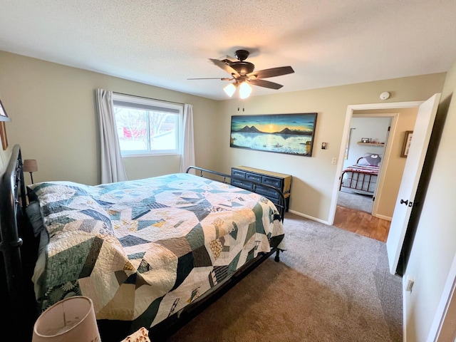 carpeted bedroom with baseboards, a ceiling fan, and a textured ceiling