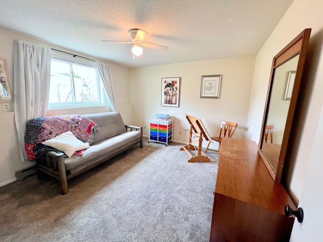 carpeted living room with a textured ceiling, ceiling fan, and baseboards