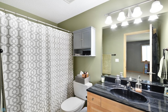bathroom featuring toilet, curtained shower, and vanity