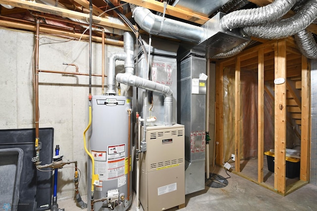 utility room featuring water heater