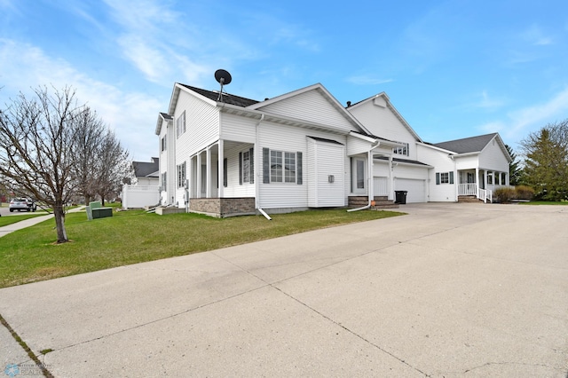 view of front of house with a garage, a front lawn, and concrete driveway