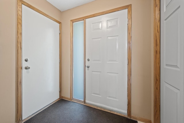 foyer entrance featuring baseboards