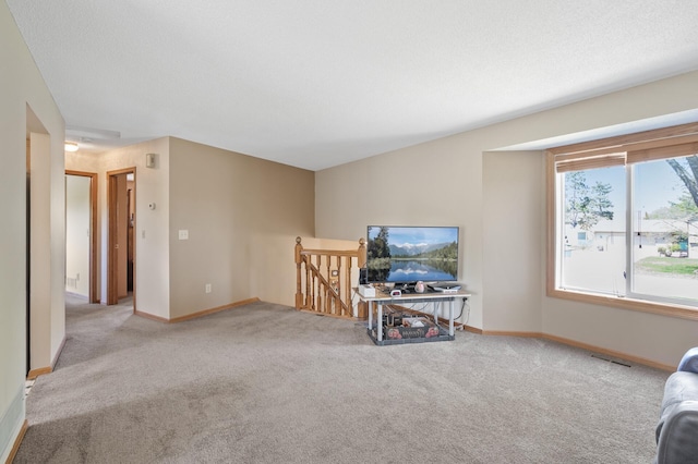 living area featuring carpet floors and baseboards