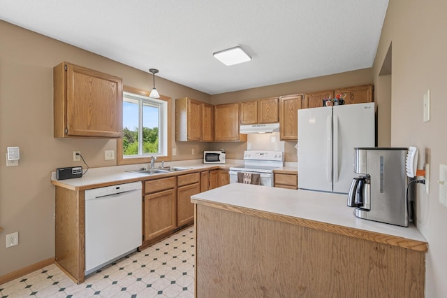 kitchen featuring white appliances, a sink, under cabinet range hood, a peninsula, and light countertops