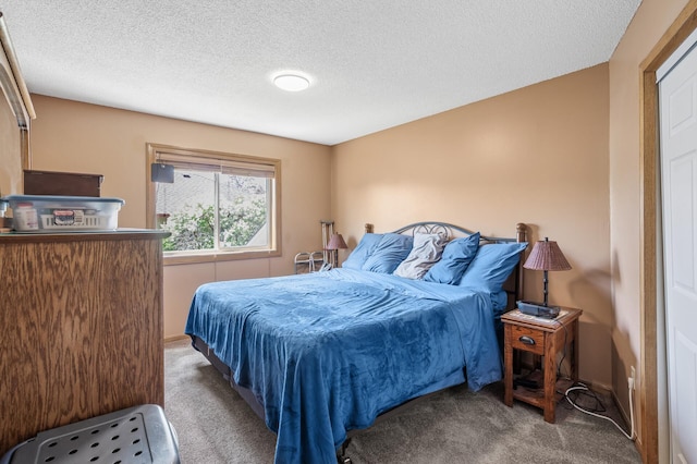 carpeted bedroom featuring a textured ceiling and baseboards