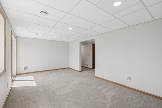unfurnished room with carpet floors, baseboards, a drop ceiling, and recessed lighting