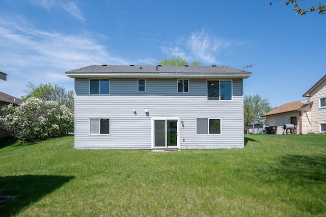 rear view of house with a yard
