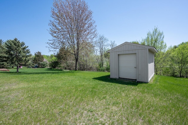 view of grassy yard with a storage unit and an outdoor structure