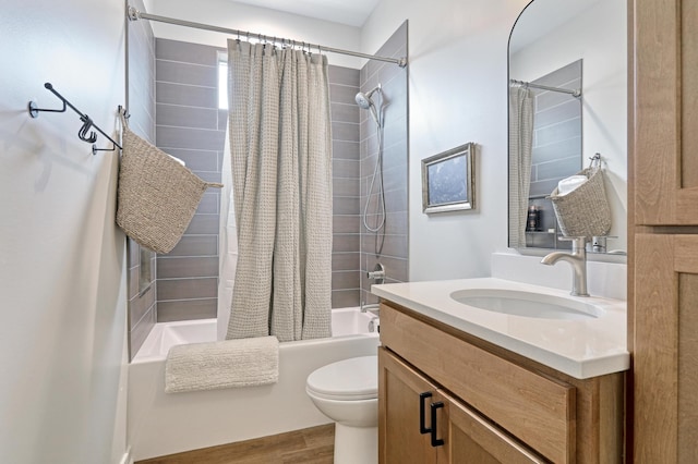 full bathroom with shower / tub combo with curtain, toilet, vanity, and wood finished floors