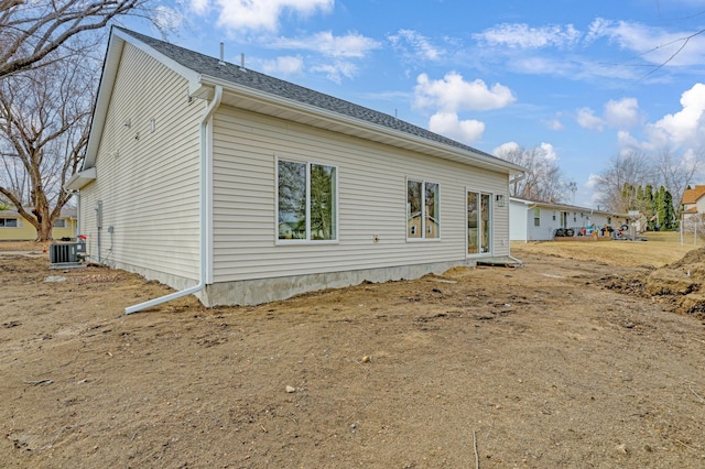 rear view of property with central AC