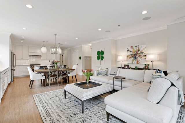 6112 Kellogg Unit 200D, Edina, MN 55424 - living area with ornamental molding, recessed lighting, light wood-type flooring, and a chandelier