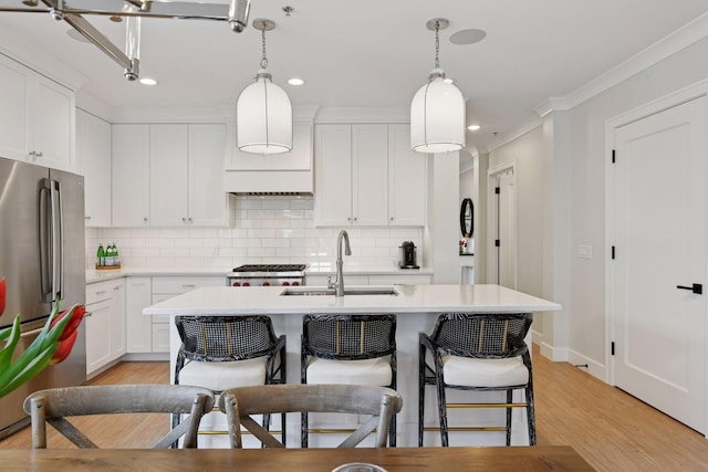 6112 Kellogg Unit 200D, Edina, MN 55424 - kitchen featuring freestanding refrigerator, a sink, light countertops, tasteful backsplash, and a center island with sink