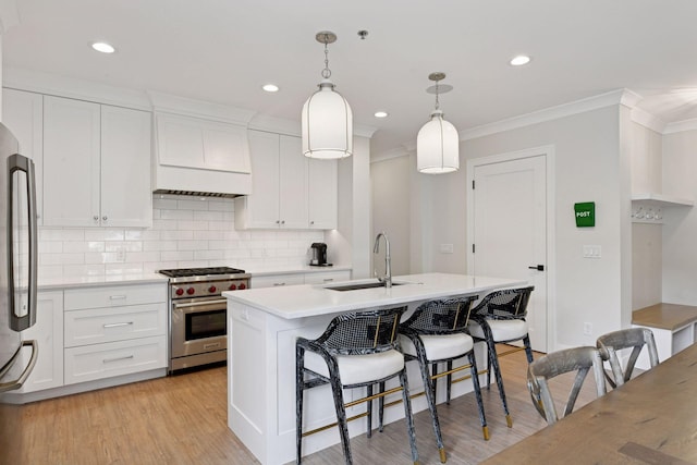6112 Kellogg Unit 200D, Edina, MN 55424 - kitchen with stainless steel appliances, a sink, crown molding, light countertops, and backsplash