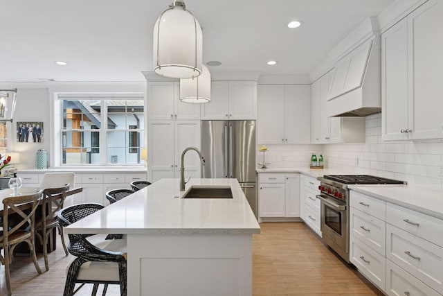 6112 Kellogg Unit 200D, Edina, MN 55424 - kitchen with stainless steel appliances, a sink, custom exhaust hood, an island with sink, and backsplash
