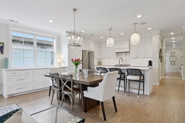 6112 Kellogg Unit 200D, Edina, MN 55424 - dining room with light wood finished floors, baseboards, a chandelier, and recessed lighting