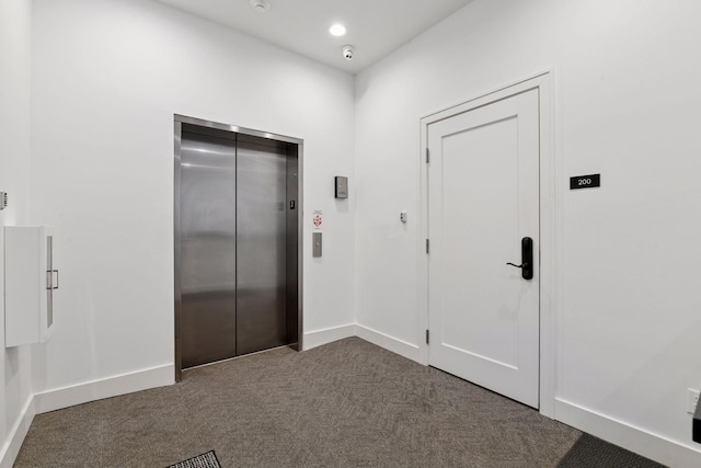 6112 Kellogg Unit 200D, Edina, MN 55424 - entrance foyer with elevator, dark carpet, and baseboards