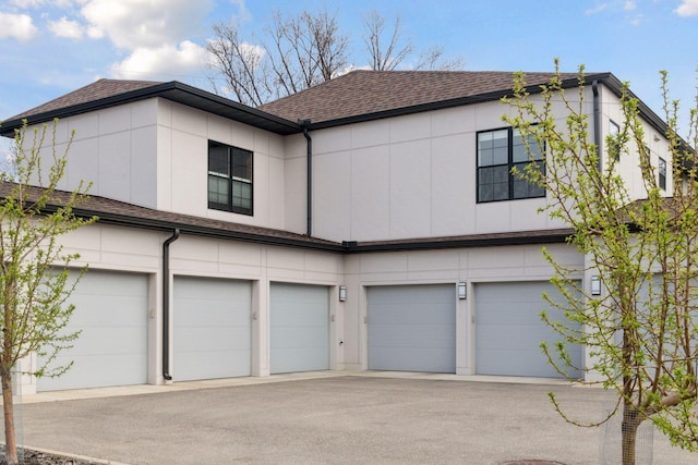 6112 Kellogg Unit 200D, Edina, MN 55424 - view of front facade featuring a garage, asphalt driveway, and a shingled roof