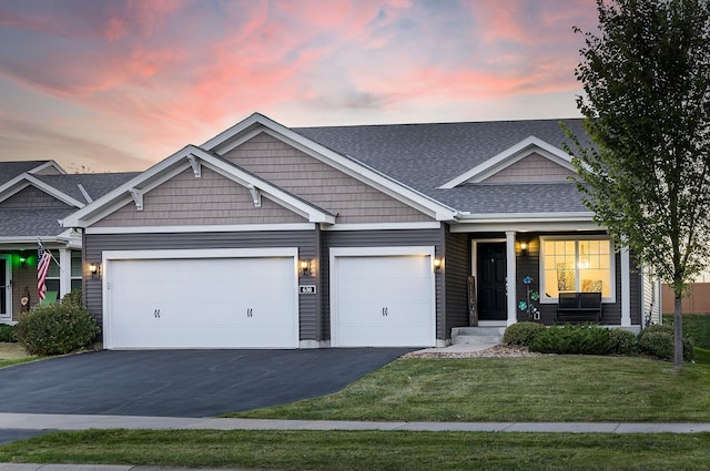 630 Stonegate Cir, Waconia, MN 55387 - view of front facade with driveway, an attached garage, a front lawn, covered porch, and a shingled roof