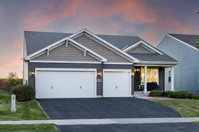 630 Stonegate Cir, Waconia, MN 55387 - craftsman-style house featuring covered porch, driveway, a shingled roof, and an attached garage