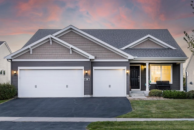 630 Stonegate Cir, Waconia, MN 55387 - craftsman inspired home with asphalt driveway, roof with shingles, a porch, a lawn, and an attached garage
