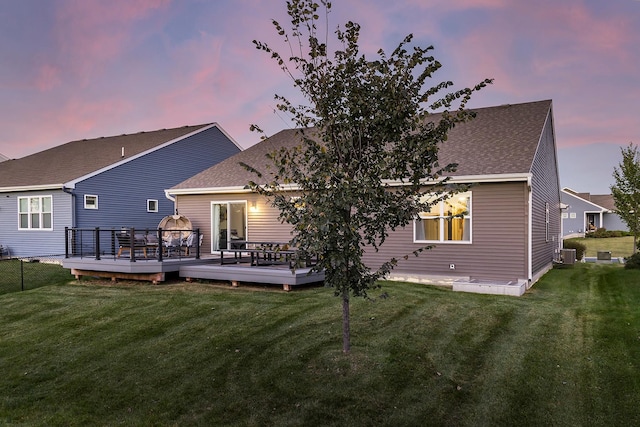 630 Stonegate Cir, Waconia, MN 55387 - back of property at dusk featuring a wooden deck, a yard, and roof with shingles
